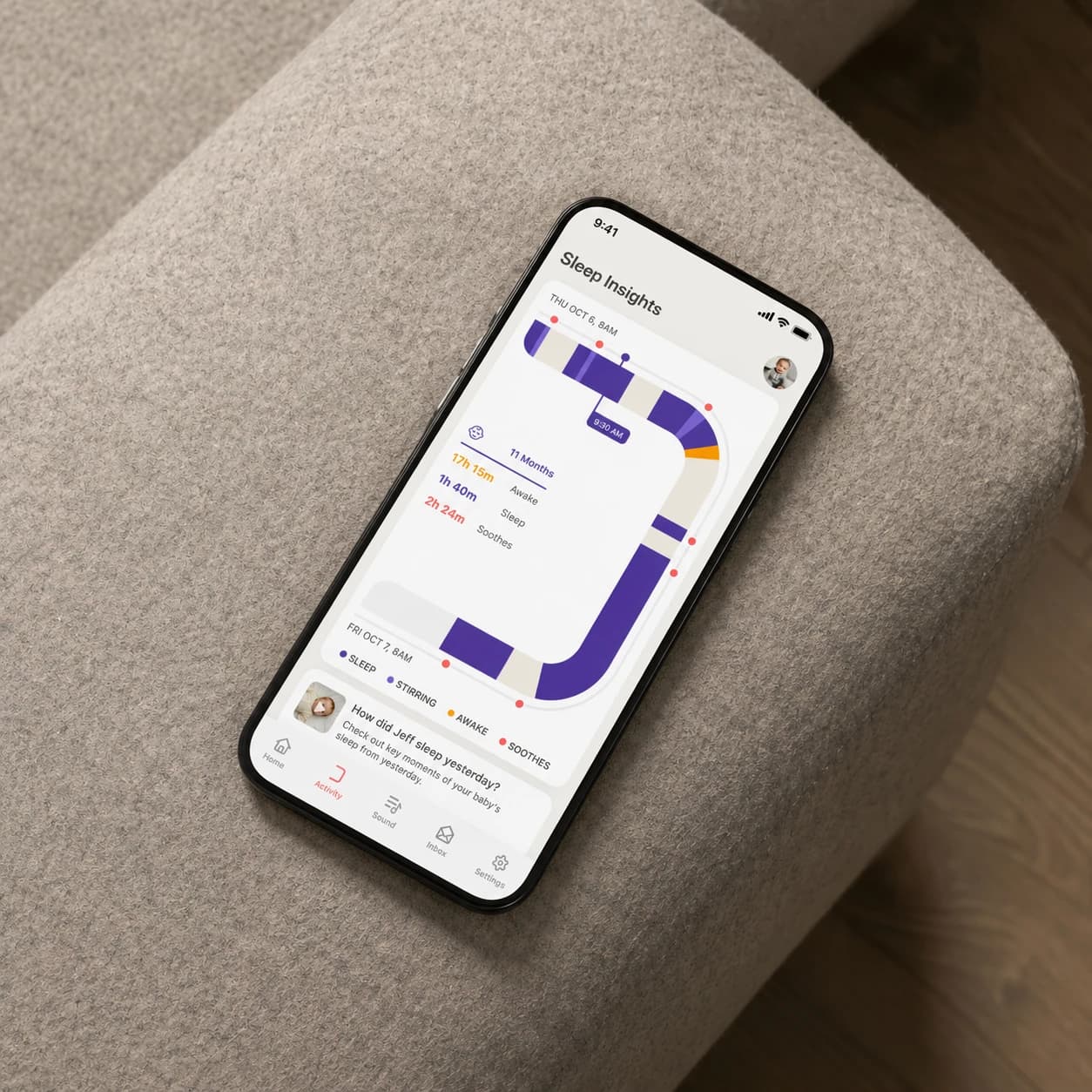 Phone resting on a couch armrest showing the Cradlewise Sleep Insights screen